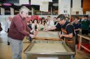 H.E. Mr. Karlis Eihenbaums,ambassador of Latvia to China, tries his hand at the traditional craft of Xuan papermaking.
